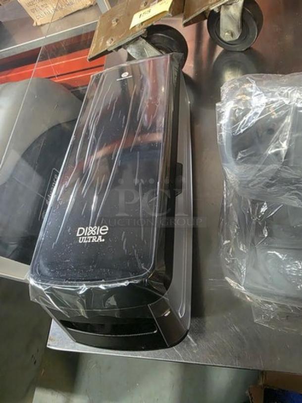 Dixie Ultra Dispenser, black finish, sleek design, new condition, with clear branding on front.