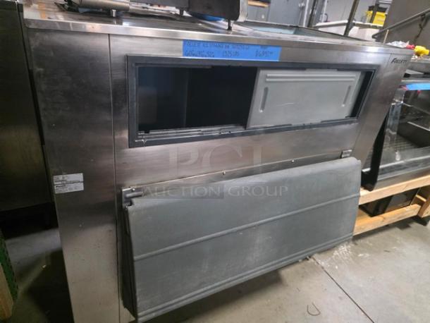 Follett Ice Storage Bin SG1325S-60, 1,325lb capacity. Stainless steel finish, front access panel. Signs of wear visible.