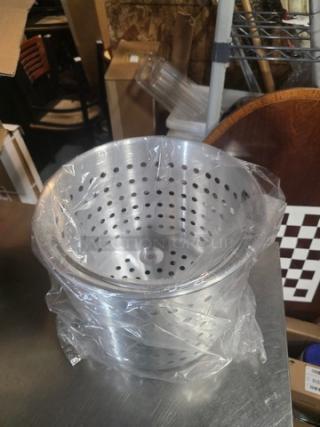 Winco Aluminum Steamer Basket, new condition, perforated design, wrapped in plastic, ideal for steaming vegetables.