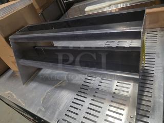 Stainless steel double speed rail, excellent condition, dual shelves for bar organization, sturdy construction, sleek design.