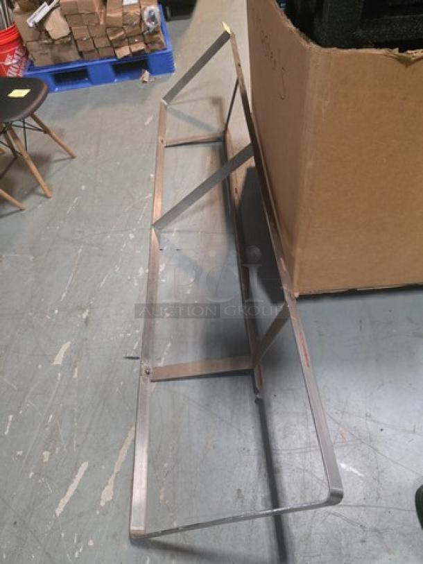 Wall mountable pot rack, metal frame, sturdy construction, minimal design, good condition, ideal for kitchen storage.