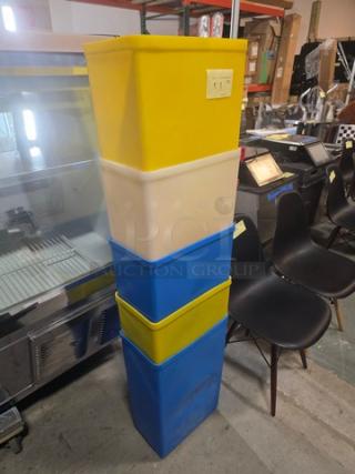 Lot of 5 plastic storage bins in various colors, stacked vertically. Used condition, slight scuff marks visible.