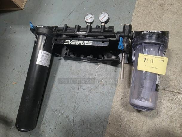 Pentair Everpure Commercial Water Filtration System with dual gauge, scale inhibitor. Black mount, good condition.