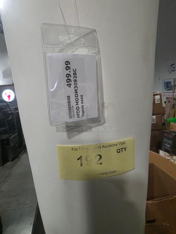 Decorative floor vase, tall cylindrical shape, white finish. Attached tag shows model number MODMODN030B, item number 249969.