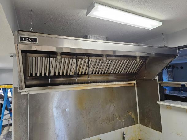 Naks 6ft commercial kitchen exhaust hood with fire suppression system, stainless steel finish, used condition. Marked "naks" on front.