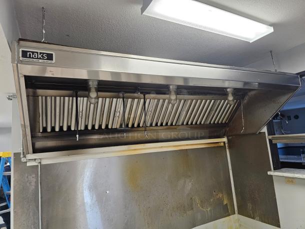 Naks 6ft commercial kitchen exhaust hood with fire suppression. Stainless steel, used condition, visible grease marks.