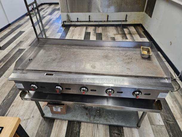 MoTak 60" natural gas griddle, stainless steel, four control knobs, no stand, used condition with minor wear.
