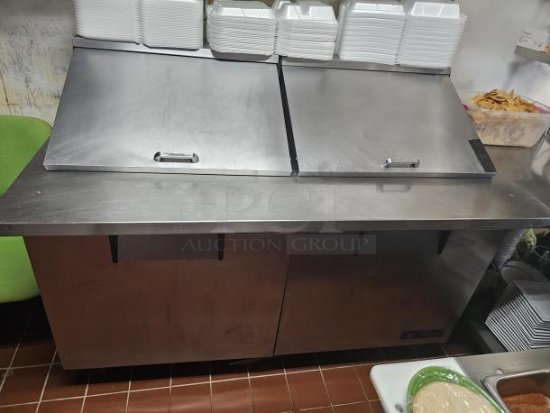 True TSSU-60 two-door prep table with stainless steel finish, tested and working, features dual lift-top storage.