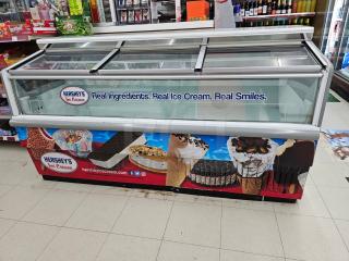 Hussmann LBN-6 freezer display case, 115V, featuring a glass top with sliding doors and Hershey's ice cream branding.