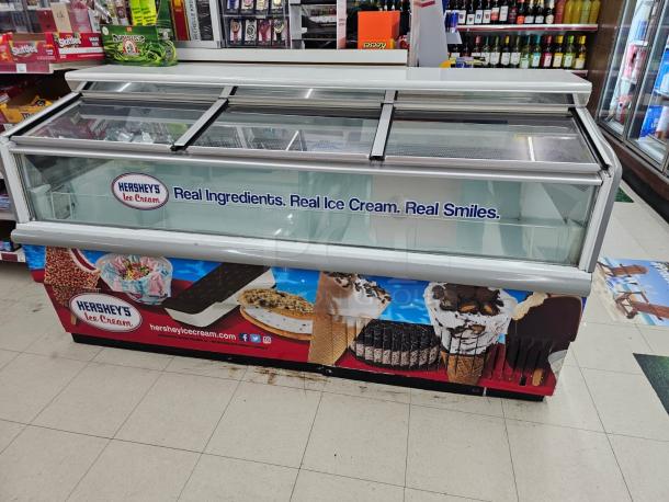 HUSSMANN LBN-6 Freezer Display Case, 115V, featuring Hershey's Ice Cream branding, glass sliding doors, good condition.