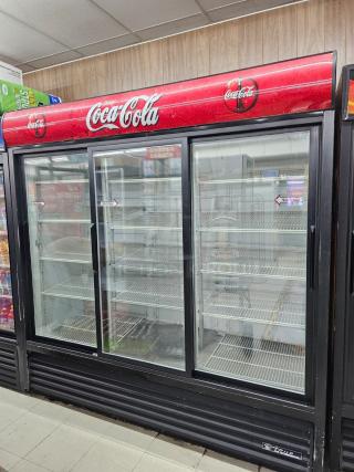 TRUE GDM-69 three glass door merchandiser, tested and working, features Coca-Cola branding, includes adjustable shelves, 115V.