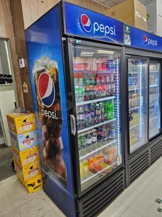 Alt Text:  
Single door Pepsi merchandiser fridge, tested and working, displaying various beverages on multiple shelves.