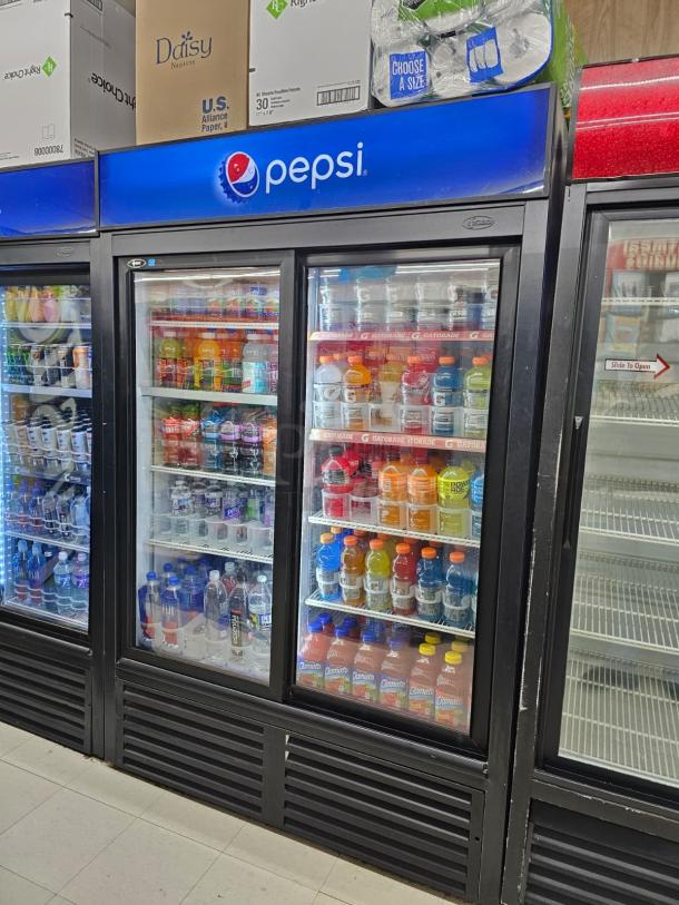 QBD CD45S glass door merchandiser, Pepsi branded, sliding doors, stocked with beverages, tested, working condition.