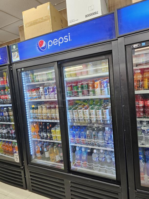 QBD CD45S two-glass door merchandiser with sliding doors, Pepsi branding, stocked with beverages, tested and working.