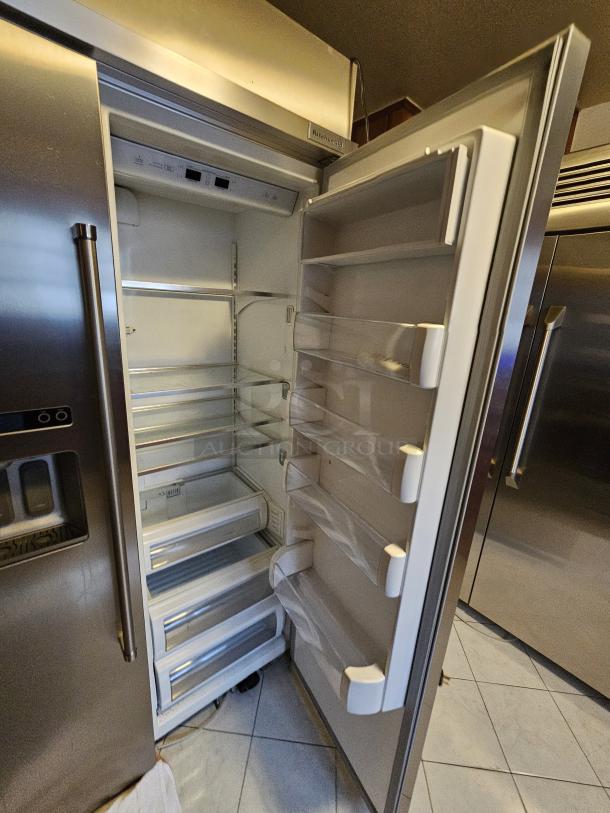 KitchenAid residential refrigerator, tested working, silver finish, spacious interior, several shelves, ice maker not functioning.