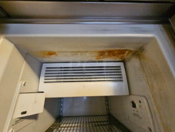 KitchenAid refrigerator interior showing a tested working unit with rust stains near the vents. Ice maker not working.