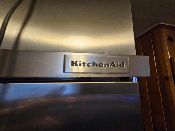 KitchenAid residential refrigerator, tested and working. Ice maker not functional. Stainless steel finish with KitchenAid logo.