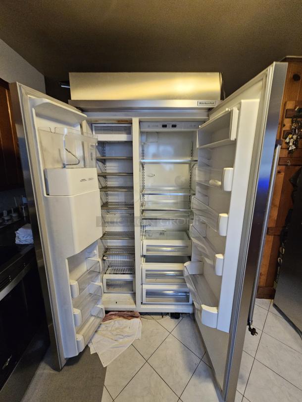 KitchenAid residential refrigerator, open view. Tested and working, ice maker not functioning. Interior shelves and bins visible.