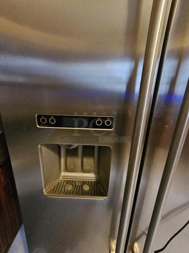 KitchenAid residential refrigerator in good condition, tested and working; features dual doors and a water dispenser; ice maker not functioning.