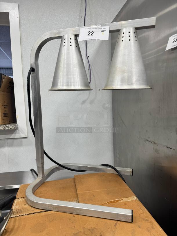 Aluminum countertop heat lamp with twin cone-shaped shades, mountable frame, good condition. Auction tag "22 QTY 5".