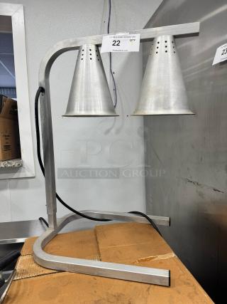 Aluminum countertop heat lamp with twin cone-shaped shades, mountable frame, good condition. Auction tag "22 QTY 5".