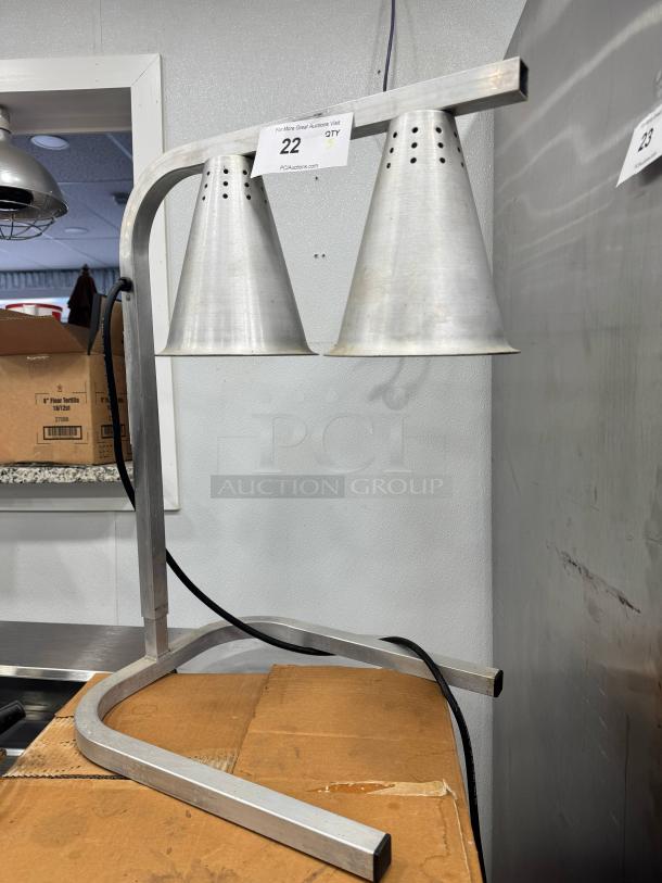 Dual-cone countertop heat lamp with metallic finish, sturdy base, and perforated shades. Good condition, ideal for food warming.