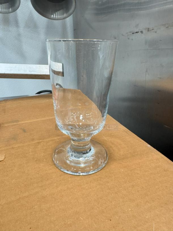 Lot of 36 highball glasses; clear glass, pedestal base, modern design. Excellent condition, ideal for entertaining.