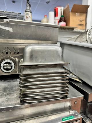 Stainless steel food pan BIDX12, stack of multiple pans, durable, suitable for commercial kitchen use, excellent condition.