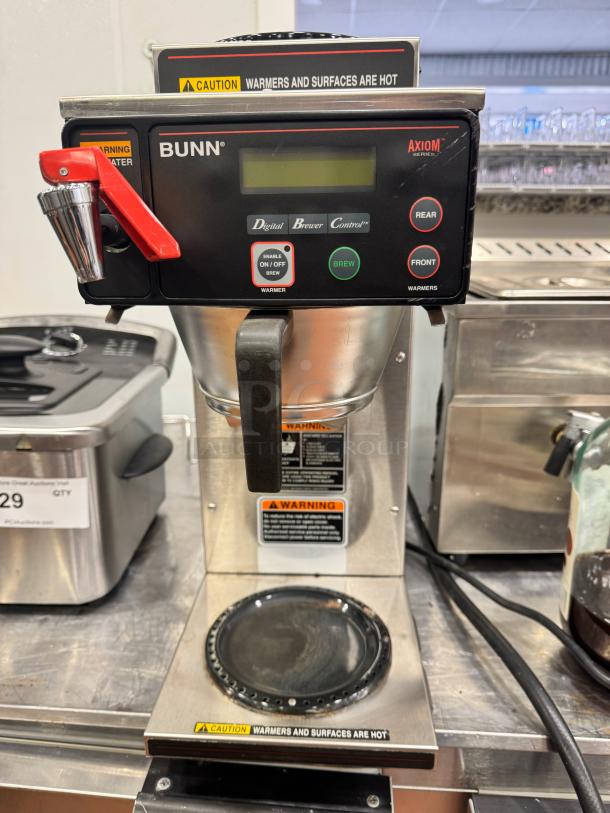 BUNN Axiom Series commercial coffee brewer with digital controls, dual warmers, and caution labels. Good condition.