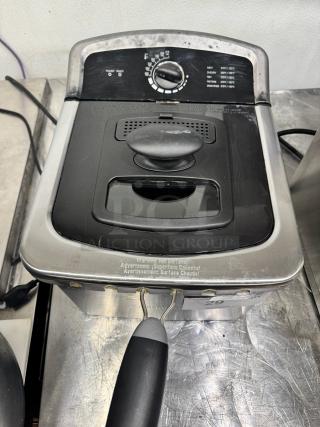 Farberware 4-liter deep fryer with temperature dial and indicator lights. Used condition, some wear visible on the surface.