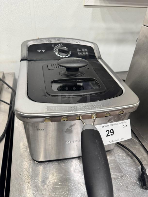 Farberware 4-liter deep fryer with dial control, stainless steel body, visible wear. Auction tag number 29 attached.
