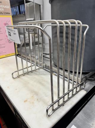 Stainless steel cutting board storage rack with slotted design, in good condition. Auction tag reads "32, QTY."