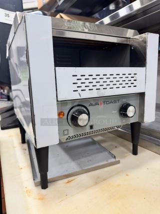 Brand new AvaToast CTA 7001 tabletop conveyor toaster, stainless steel with control knobs and "Caution Hot" marking.