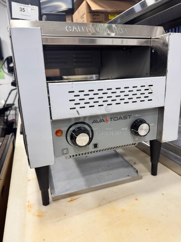 Brand new AvaToast CTA 7001 tabletop conveyor toaster; features adjustable controls, "Caution Hot" label, and durable construction.
