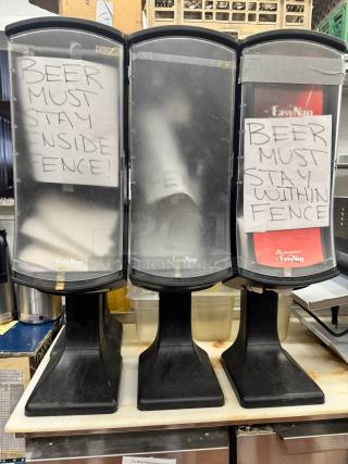 Lot of 3 EasyNap napkin dispensers, black plastic, "Beer must stay inside fence" signs, used condition.
