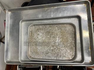 Lot of 7 metal baking pans, showing surface wear and tarnish, all sold together. Suitable for various baking needs.