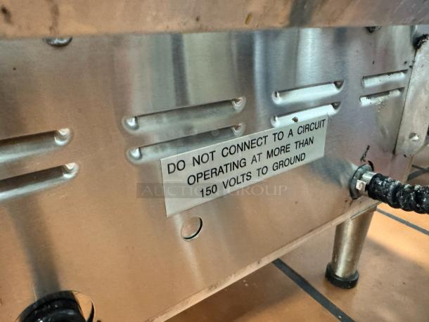 Star Pro-Max Panini Grill base with vented metal surface; labeled warning "Do not connect to a circuit operating at more than 150 volts to ground."