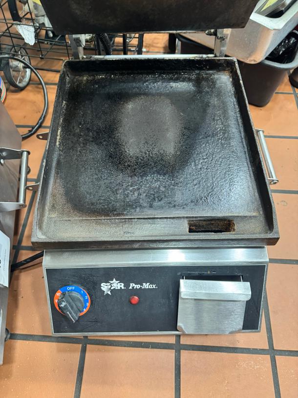 Star Pro-Max Panini Grill, used condition with visible wear. Features temperature control dial, stainless steel exterior, 15" cooking surface.