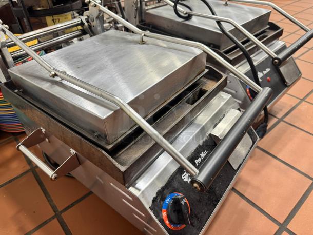 Star Pro-Max Panini Grill in stainless steel. Features temperature dial and robust handle. Appears in used condition.
