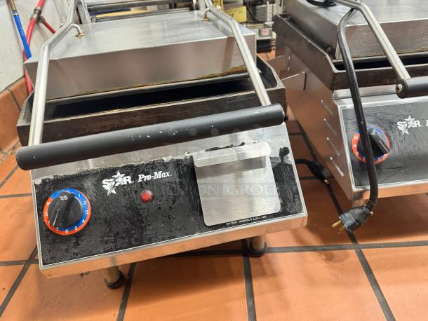 Star Pro-Max Panini Grill with adjustable temperature dial, stainless steel body, used condition, visible wear.