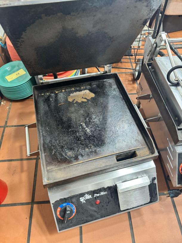Star Pro-Max Panini Grill with dual temperature controls, stainless steel body, wear on grill surface, suitable for commercial use.