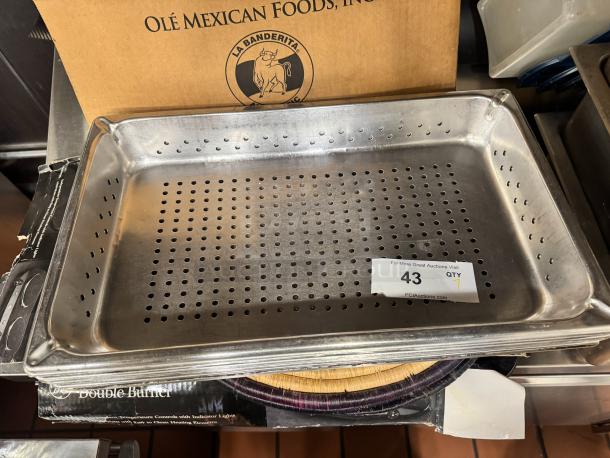 Stainless steel full-size steam pan, perforated, in used condition. Auction label reads "43 QTY" from PCI Auctions.