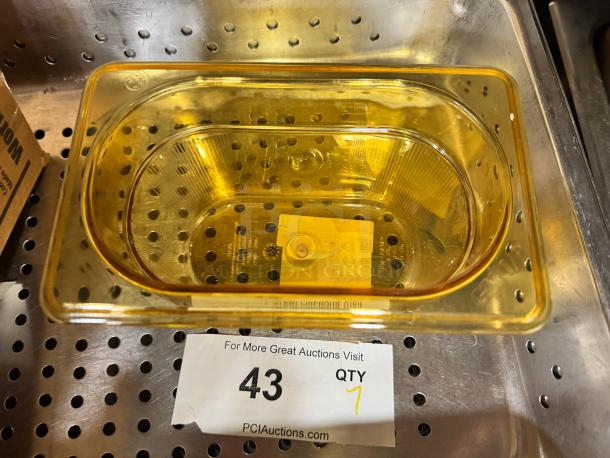 Rubbermaid 1/9 Food Pan, brand new, amber color, clear polycarbonate, durable, with visible manufacturer markings.