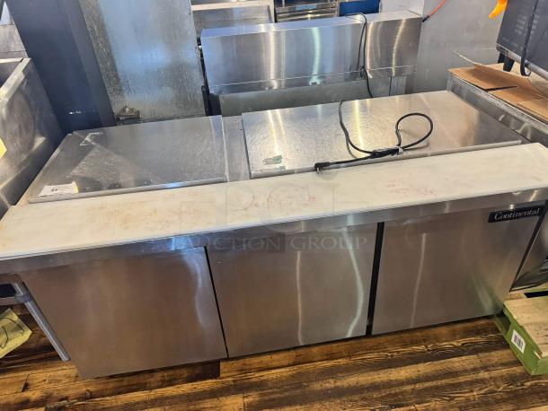 Continental SW72-30M 3-door prep table, tested and working. Note: one handle is broken. Stainless steel exterior.