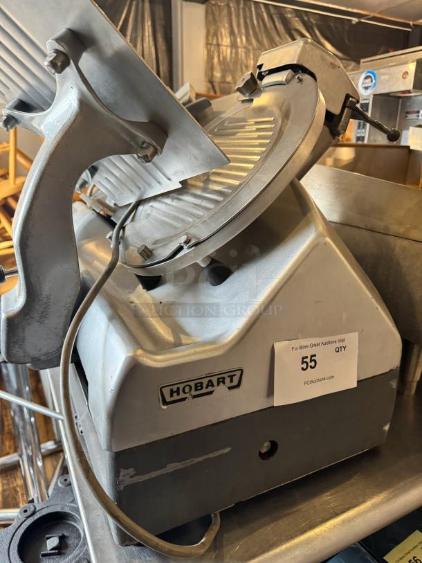 Hobart 2912 commercial meat slicer, sturdy metal construction, used condition, visible brand label, auction number tag.