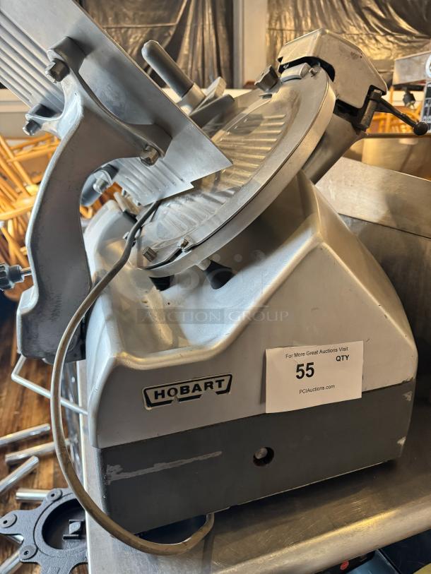 Hobart 2912 commercial meat slicer, sturdy metal build, used condition with visible wear, Hobart logo on base.
