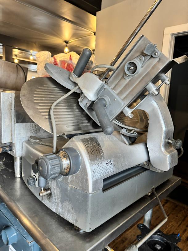 Hobart 2912 commercial meat slicer, silver, used condition, adjustable settings, visible brand label and control knob.