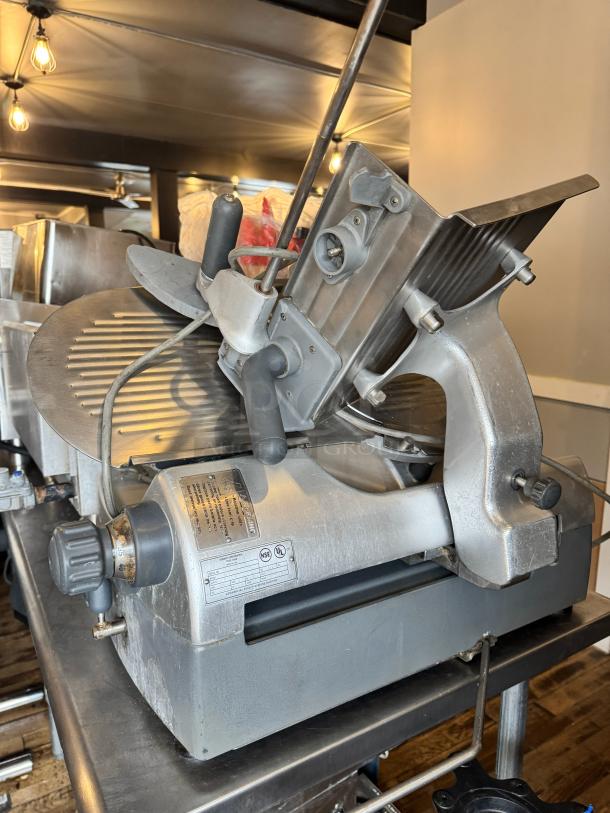 Hobart 2912 commercial meat slicer, with adjustable blade, in good condition. Features power knobs and visible model markings.