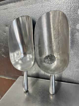 Lot of 2 aluminum scoops, 85oz each. One scoop shows wear with a visible dent. All items for one price.