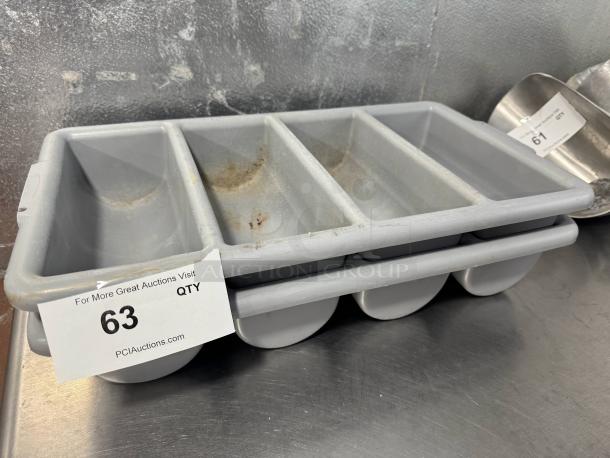Lot of 2 gray plastic cutlery bins, each with 4 compartments. Used condition with visible rust stains. Auction tag number 63 shown.